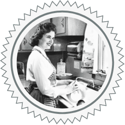 Black and white photo of woman in the kitchen, not worrying about her plumbing. A Plumb Pros Inc. image.