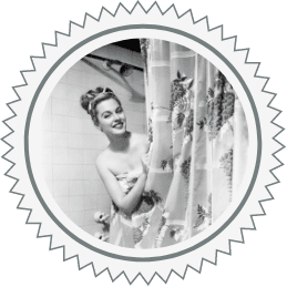 Black and white image of woman behind shower curtain. Used for Plumb Pros Inc., water heater service section of homepage.